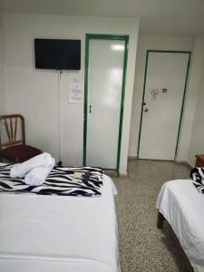 Letto o letti in una camera di Hotel Casa Verde Guatapé