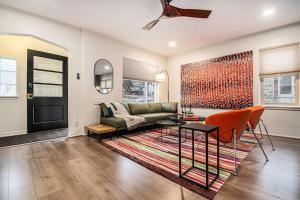 a living room with a couch and a table at Relaxing Spot with Zen Garden & Year-Round Hot Tub in Omaha