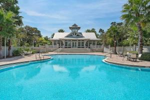 a large swimming pool in front of a house at Narnia Grande Pointe Villa - Inlet Beach Pool & Clubhouse Access in Inlet Beach