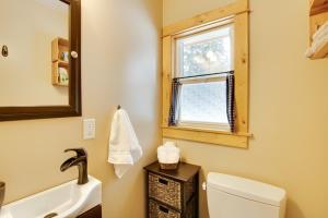 a bathroom with a toilet and a sink and a mirror at Deck and Fire Pit Yakima River Retreat in Cle Elum in Cle Elum +25 photos