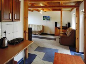 a kitchen with a counter and a living room at Apartment in Szczecin near Puszcza Bukowa in Szczecin