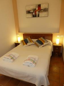 a bedroom with a white bed with two pillows at Karmapartment in Seville