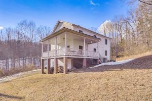 a large house with a porch on a field at Family Home with Game Room and Decks in Etlan! in Etlan