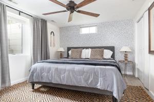 a bedroom with a bed and a ceiling fan at Peaceful Gem HotTub Fenced Yard & Near Downtown in Omaha
