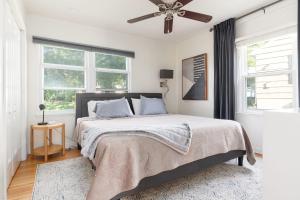 a bedroom with a bed with a ceiling fan at Peaceful Gem HotTub Fenced Yard & Near Downtown in Omaha