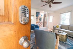 a door with a remote control in a living room at Peaceful Gem HotTub Fenced Yard & Near Downtown in Omaha +33 photos