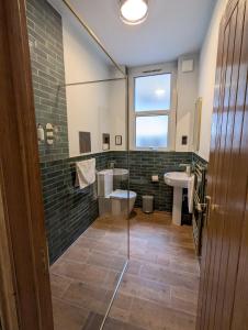 a bathroom with a toilet and a sink and a window at Central London Apartment - Great Location in London +99 photos