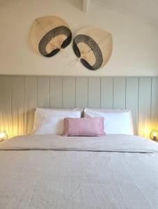 a bedroom with a bed with two baskets on the wall at vakantiewoning 266 in De Panne +50 photos