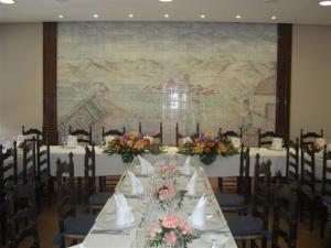 a long table in a room with a large map at Hotel Cariñena in Cariñena