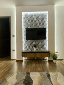 a living room with a television on a wall at Pegazus Apartman in Keszthely