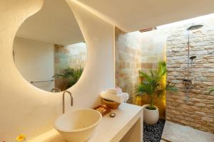 a bathroom with a sink and a shower at Living Asia Resort and Spa in Senggigi