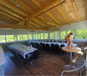 a large room with tables and chairs in it at Vikendica Avram-Plane in Plane