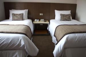 Rúm í herbergi á Hotel Martín Gusinde
