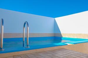 a swimming pool with blue water and two faucets at Dakhla oasis in Dakhla
