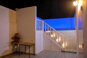 a room with a staircase with a guitar on a table at Dakhla oasis in Dakhla