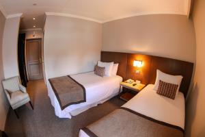Rúm í herbergi á Hotel Martín Gusinde