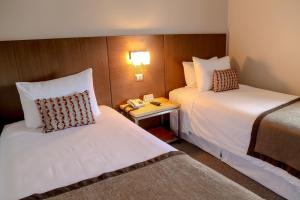 Rúm í herbergi á Hotel Martín Gusinde