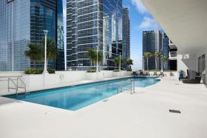 a swimming pool in a city with tall buildings at Studios in Brickell with Pool, Gym, free parking and Game Room in Miami