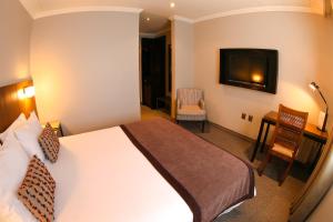 Rúm í herbergi á Hotel Martín Gusinde