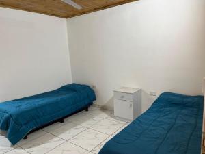 a bedroom with two beds and a night stand at Yateí in Puerto Iguazú