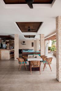 a dining room with a table and chairs at Living Asia Resort and Spa in Senggigi