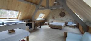 a kitchen and a bedroom with a bed in a attic at Quercynoise de Charme Piscine et vue sur Vallée du LOT in Balaguier-dʼOlt