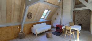 a living room with a white chair and a table at Quercynoise de Charme Piscine et vue sur Vallée du LOT in Balaguier-dʼOlt +24 photos