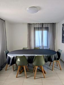 a dining room with a blue table and chairs at SiYen three with 24h Check-in in Ammerbuch