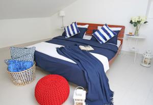 a bedroom with a bed with blue and white pillows at Apartments Stefani in Fažana