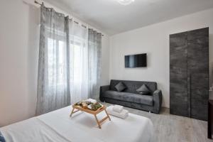 a living room with a bed and a couch at La Venezia Station Residence Mestre in Mestre