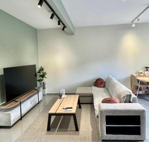 a living room with a couch and a tv at LĀr - the Hidden Gem in Anatolí