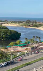 a river with cars parked on the side of a road at Casa China & Silva, Otima Casa para praia ou descanso, proximo as Dunas da Sabiaguaba e shoppings em Eusebio e Fortaleza Ce in Eusébio