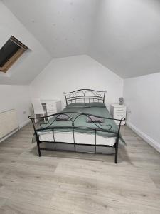 a bedroom with a bed in a white room at CR0 Purley Way Serviced Accommodation in Croydon +18 photos