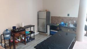 a kitchen with a stainless steel refrigerator in a room at Casa Tania playa larga in Agua de Correa