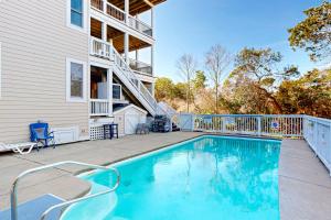 a swimming pool in front of a house at The Oaks #15-11 in Avon