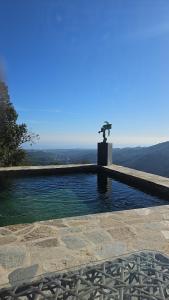 a swimming pool with a cross on top of it at Domaine COLONNA SANTINI ,Chambre d hôtes Piscine, sauna, spa in Porri