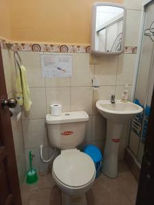 a small bathroom with a toilet and a sink at Lobito in Puerto Baquerizo Moreno