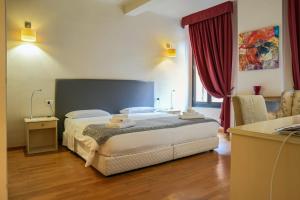 Postel nebo postele na pokoji v ubytování Honey Rooms Ferrara