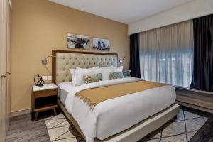 a bedroom with a large bed and a large window at Casa Malí by Dominion Boutique Hotel in Mexico City