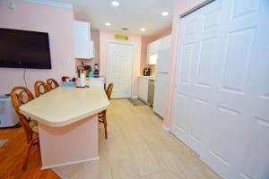 a kitchen with a white door and a table and chairs at Club Ocean Villas II 182 condo in Ocean City
