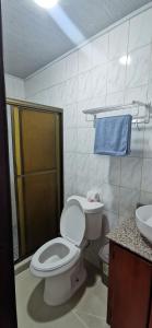 a bathroom with a toilet and a sink at El Paso de Almirante in Almirante