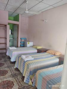 Giường trong phòng chung tại Hospedaje doña Gladys