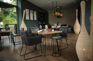 a restaurant with tables and chairs in a room at Domaine Le Verbois in Chantilly