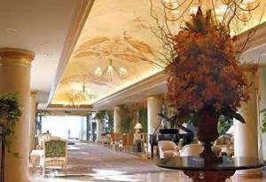 a lobby with a vase of flowers on a table at San Luis Resort Galveston efficiency condo in Galveston
