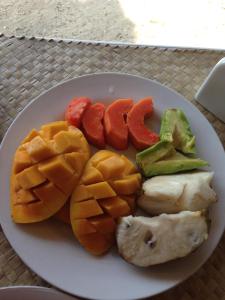 a plate of fruits and vegetables on a table at Buenavista Paradise Resort in Looc