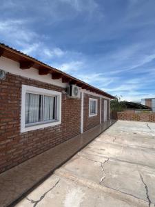a brick house with a parking lot next to it at La Amarilla in Santa María