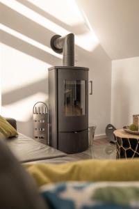 a living room with a fireplace in the corner of a room at Ostsee - Appartement Nr 65 "Seaside" inkl Strandkorb im Strand Resort in Heiligenhafen