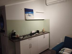a kitchen with a sink and a counter top at Goccia di Mare monolocale in Roseto Capo Spulico