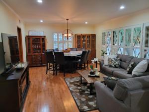 a living room with a couch and a table at Extremely Chill 3 Bedroom Home in Long Beach