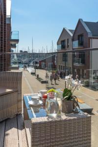 a table with a tray of food on a balcony at Ostsee - Appartement Nr 89 "Salzaster" im Strand Resort in Heiligenhafen